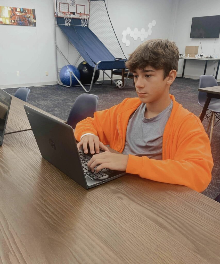 online student working on a laptop in a learning lab